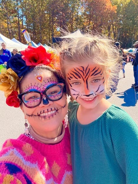Face paint, flowers, and a tiger